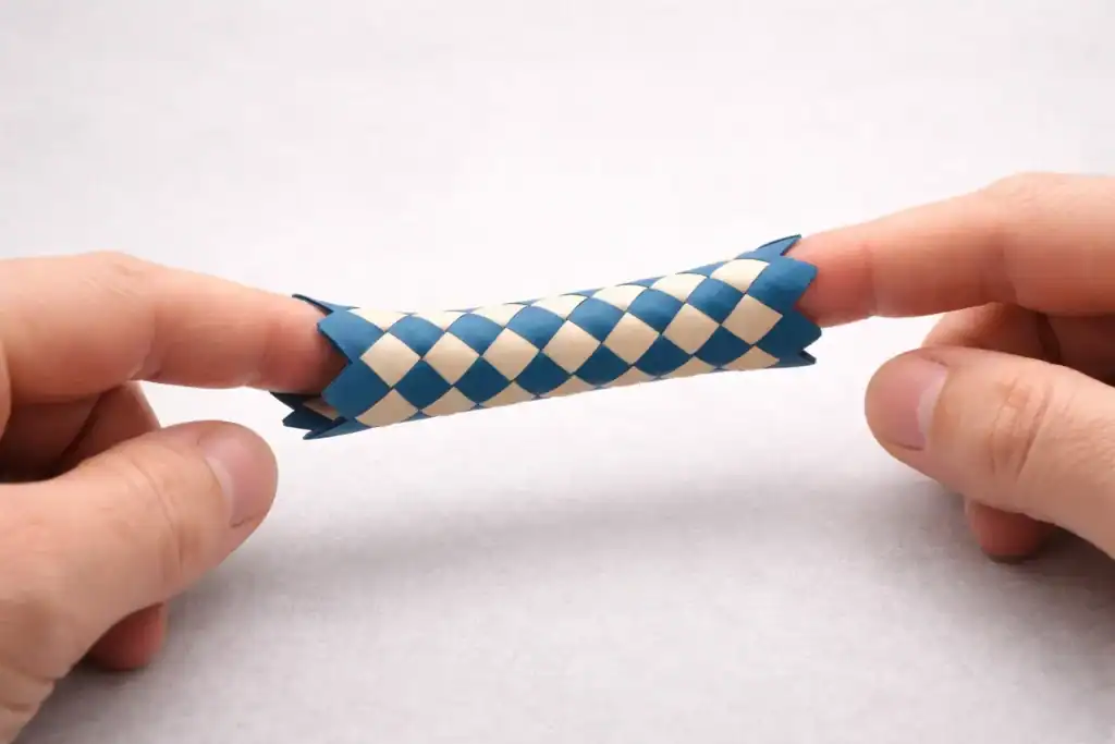Chinese finger trap with two fingers pulling apart, illustrating how trying to force certainty can strengthen the rumination cycle in false memory OCD